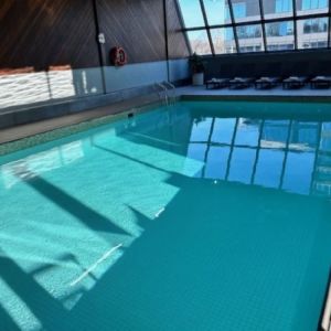 Relaxing indoor pool with lounge chairs at Atlantica Hotel Halifax.