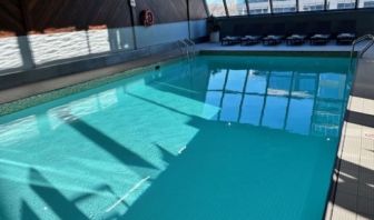 Relaxing indoor pool with lounge chairs at Atlantica Hotel Halifax.