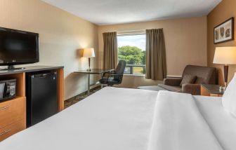 Standard day use room with TV, work desk and sofa at Comfort Inn Pembroke.