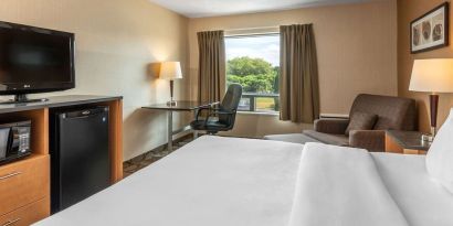 Standard day use room with TV, work desk and sofa at Comfort Inn Pembroke.