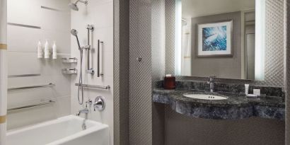 Guest bathroom with shower and tub at Crystal Gateway Marriott.