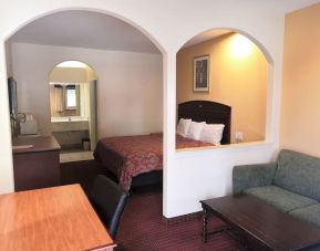 Day use room with sofa and work desk at Scottish Inn & Suites.