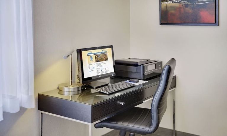 Business center with computer, printer and ergonomic chair at Comfort Inn Gatineau.