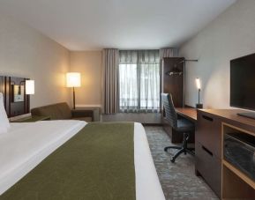 Bright and spacious day use room with TV, work desk and sofa at Comfort Inn Fredericton.