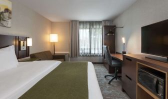 Bright and spacious day use room with TV, work desk and sofa at Comfort Inn Fredericton.