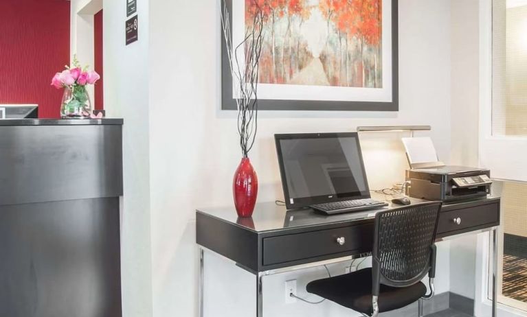 Business center with computer, printer and ergonomic chair at Comfort Inn Fredericton.