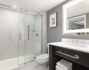 Guest bathroom with shower and free toiletries at Embassy Suites By Hilton Toronto Airport.