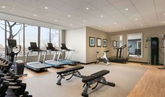 Fully equipped fitness center with window view at the Embassy Suites by Hilton Toronto Airport.