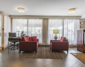 The hotel lobby has comfortable seating, and is brightly lit thanks to large windows.