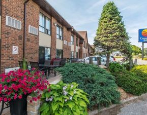 Hotel exterior with beautiful sitting area at Comfort Inn Sault Ste. Marie.