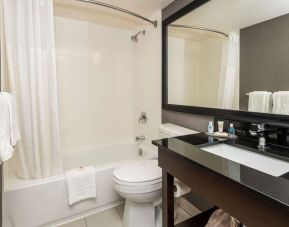 Guest bathroom with tub and free toiletries at Comfort Inn Sault Ste. Marie.