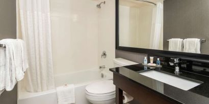 Guest bathroom with tub and free toiletries at Comfort Inn Sault Ste. Marie.