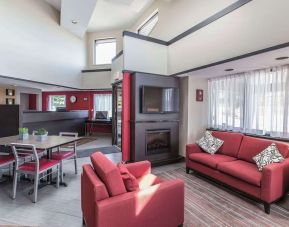 Lobby lounge with workspace and fireplace at Comfort Inn Sydney.