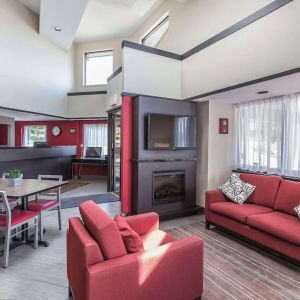 Lobby lounge with workspace and fireplace at Comfort Inn Sydney.