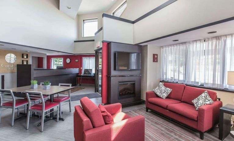 Lobby lounge with workspace and fireplace at Comfort Inn Sydney.