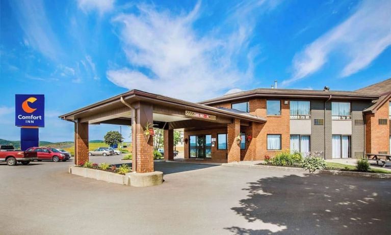 Hotel exterior and parking area at Comfort Inn Sydney.