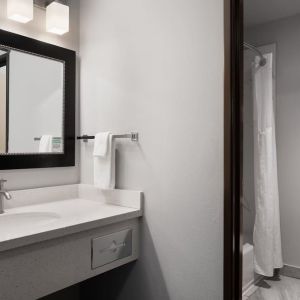 Guest bathroom with shower and tub at Garner By IHG.