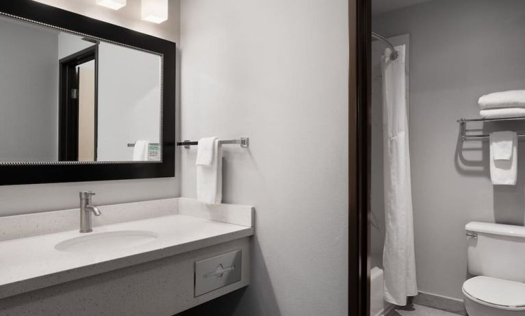 Guest bathroom with shower and tub at Garner By IHG.