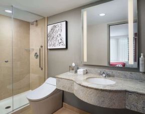 Guest bathroom with shower at Hilton Garden Inn New York/West 35th Street.