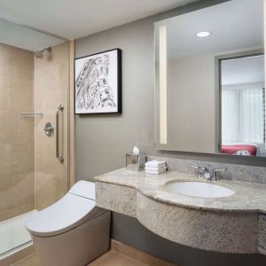 Guest bathroom with shower at Hilton Garden Inn New York/West 35th Street.