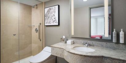 Guest bathroom with shower at Hilton Garden Inn New York/West 35th Street.