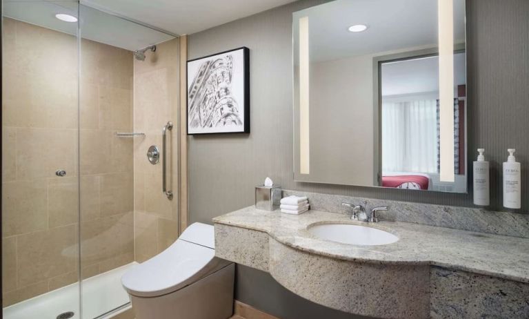 Guest bathroom with shower at Hilton Garden Inn New York/West 35th Street.