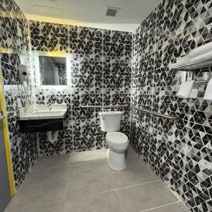 Bathroom with shower  at Days Inn Chinatown NYC.