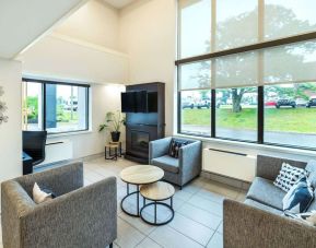 Stylish lobby lounge with TV screen, fireplace and comfortable seating at Comfort Inn Charlottetown.