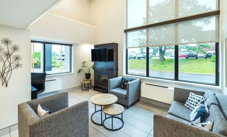 Stylish lobby lounge with TV screen, fireplace and comfortable seating at Comfort Inn Charlottetown.