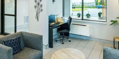 Hotel lobby workspace with computer, printer and ergonomic chair at Comfort Inn Charlottetown.