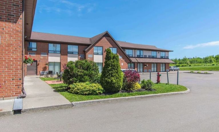 Hotel exterior with lounge seating and parking area at Comfort Inn Moncton Magnetic Hill.