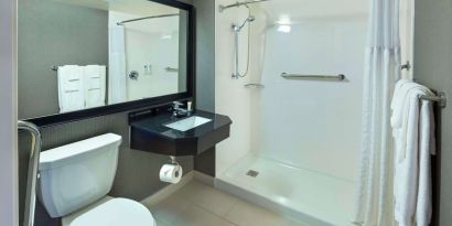 Guest bathroom with shower and free toiletries at Comfort Inn Moncton Magnetic Hill.