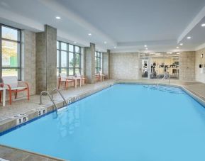 Indoor heated pool with lounge chairs at Holiday Inn & Suites Oakville At Bronte.