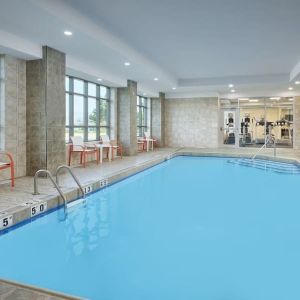 Indoor heated pool with lounge chairs at Holiday Inn & Suites Oakville At Bronte.