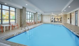 Indoor heated pool with lounge chairs at Holiday Inn & Suites Oakville At Bronte.