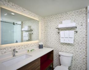 Guest bathroom with shower and free toiletries at Holiday Inn & Suites Oakville At Bronte.