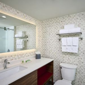 Guest bathroom with shower and free toiletries at Holiday Inn & Suites Oakville At Bronte.