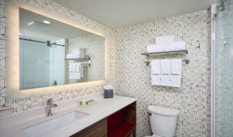 Guest bathroom with shower and free toiletries at Holiday Inn & Suites Oakville At Bronte.