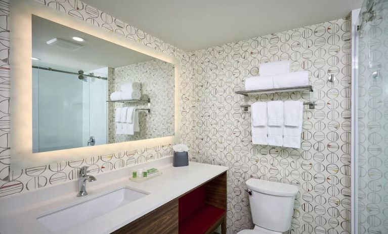 Guest bathroom with shower and free toiletries at Holiday Inn & Suites Oakville At Bronte.