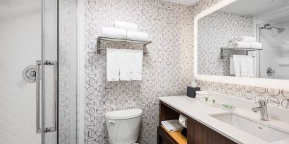 Guest bathroom with shower and free toiletries at Holiday Inn Toronto Airport East.