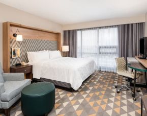 Day use room with work desk and sofa at Holiday Inn Toronto Airport East.