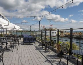 Terrace sitting area with waterfront view at Holiday Inn Kingston Waterfront.