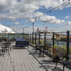 Terrace sitting area with waterfront view at Holiday Inn Kingston Waterfront.