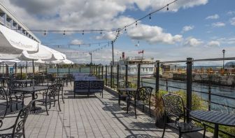 Terrace sitting area with waterfront view at Holiday Inn Kingston Waterfront.