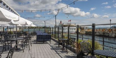 Terrace sitting area with waterfront view at Holiday Inn Kingston Waterfront.