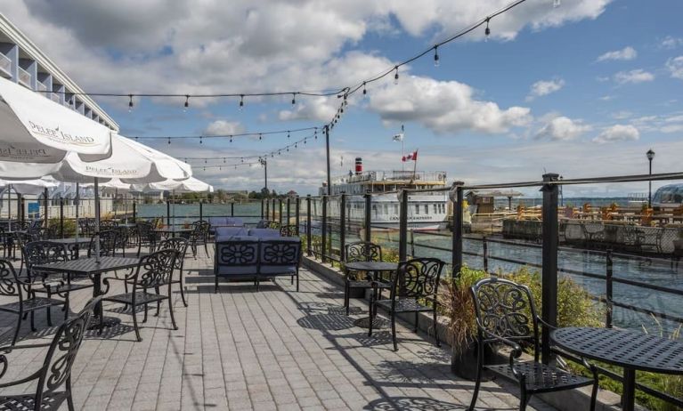 Terrace sitting area with waterfront view at Holiday Inn Kingston Waterfront.