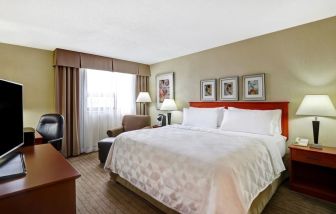 Bright and spacious day use room with work desk and sofa at Holiday Inn Laval Montreal.