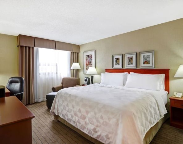 Bright and spacious day use room with work desk and sofa at Holiday Inn Laval Montreal.