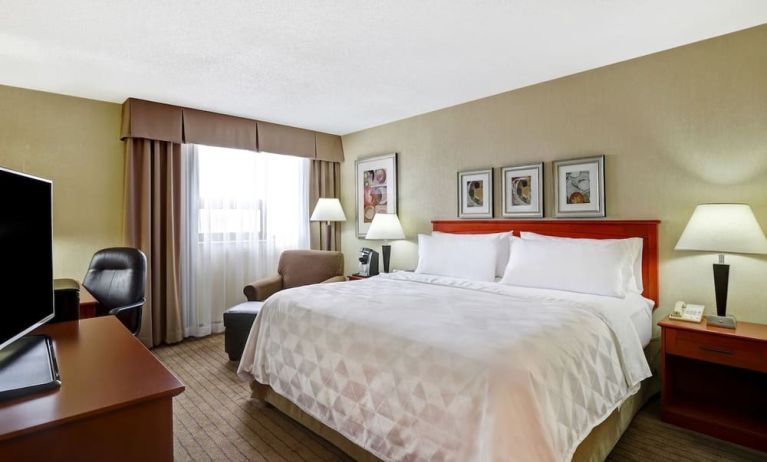 Bright and spacious day use room with work desk and sofa at Holiday Inn Laval Montreal.