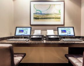 Business center with computers, printers and ergonomic chairs at Holiday Inn Laval Montreal.